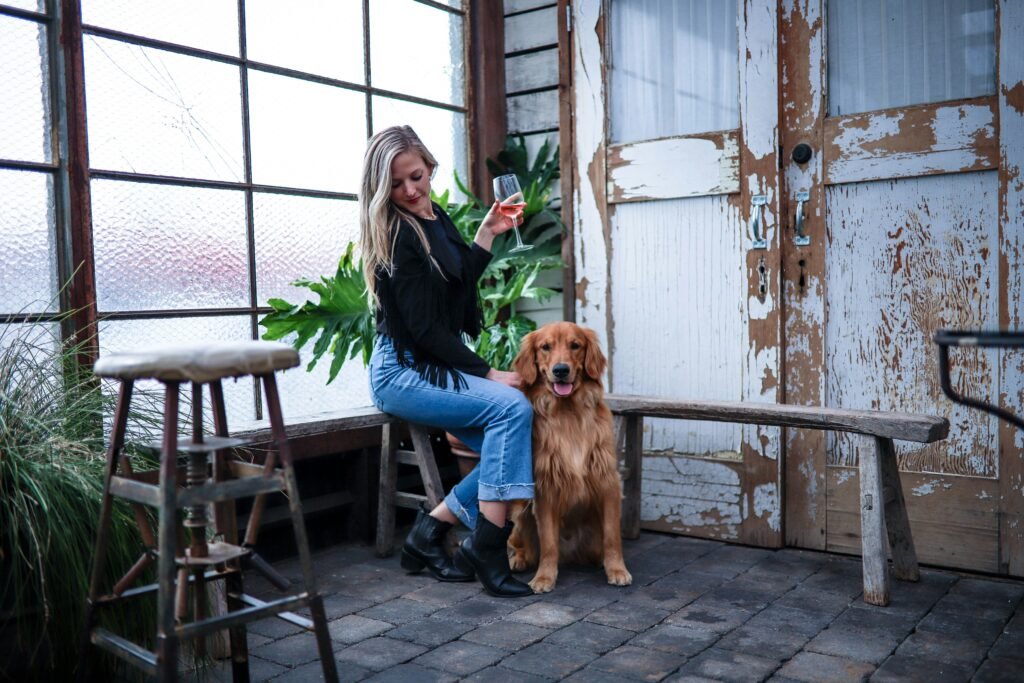 woman sitting chair beside the dog